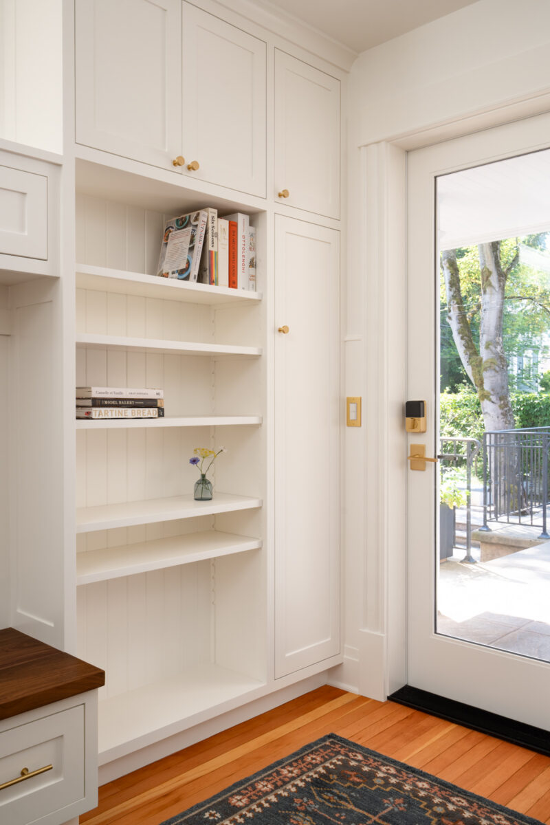 Capitol Hill entry with built-in white shelving beside a glass back door
