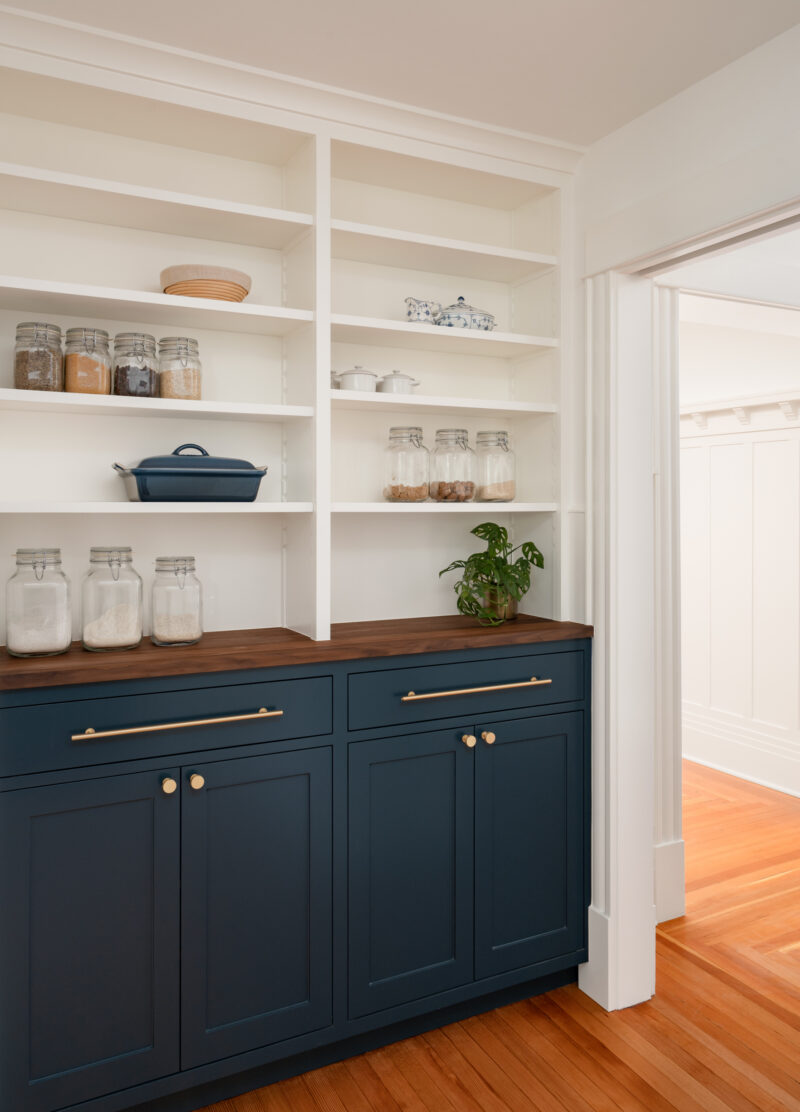 Capitol Hill pantry with open white shelving above navy cabinets with a walnut counter