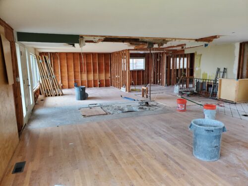 Construction photo of North Beach main floor demolition with walls opened to the studs
