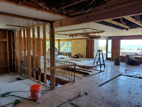 Construction photo of the North Beach interior during demolition with the old stairwell exposed