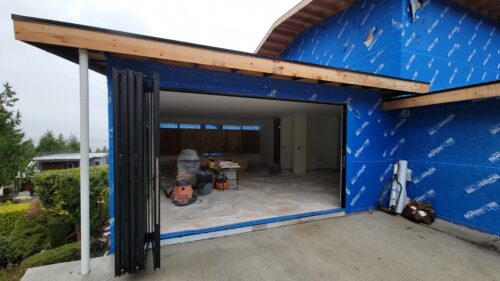 Construction photo of the North Beach folding glass wall installed before exterior siding