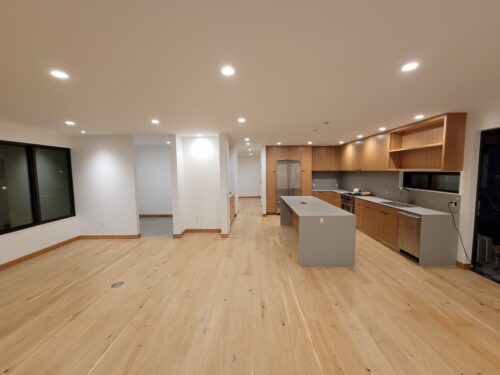 Construction photo of the North Beach kitchen with cabinets and island installed before final finishes